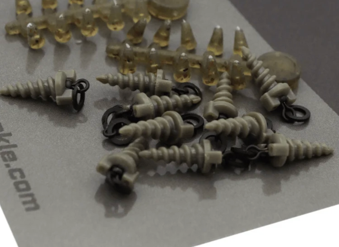 Assorted hook beads and bait screws displayed on a gray background for fishing enthusiasts.