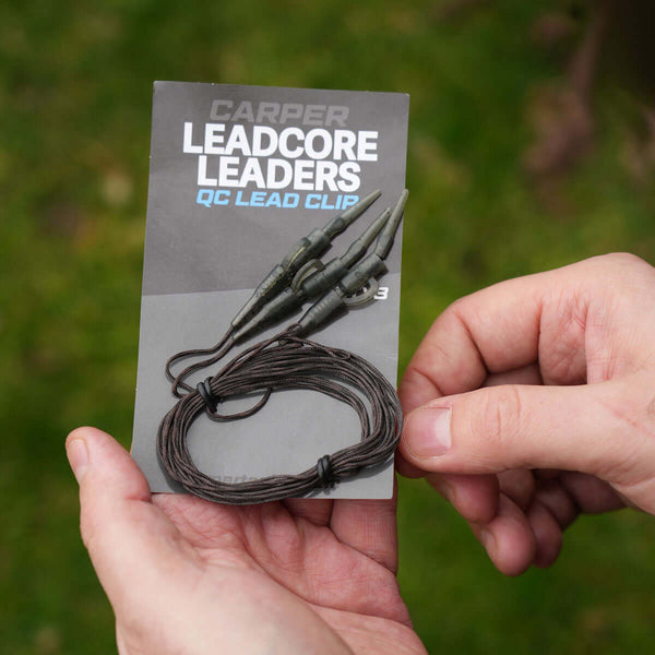 Hands holding a package of Lead Clip Leadcore Leaders with three leaders included.