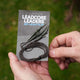 Hands holding a package of Lead Clip Leadcore Leaders with three leaders included.
