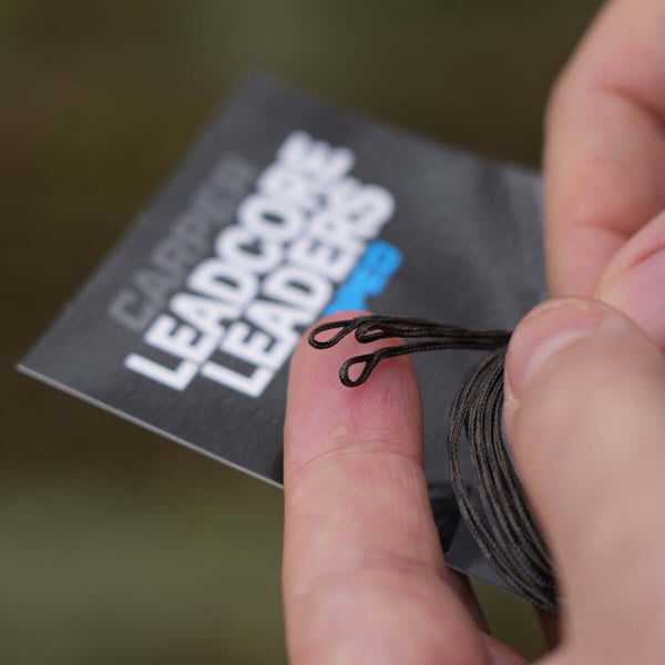 Looped leadcore fishing leaders in hand, showcasing two loops at the end and packaging details.