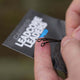 Looped leadcore fishing leaders in hand, showcasing two loops at the end and packaging details.