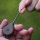 Hand attaching looped leadcore fishing leaders to a lead weight for effective fishing.